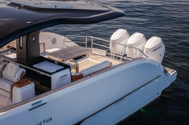 Slide: The Image of 2025 Invictus TT430 yacht with triple Mercury outboard engines on calm water. - 97