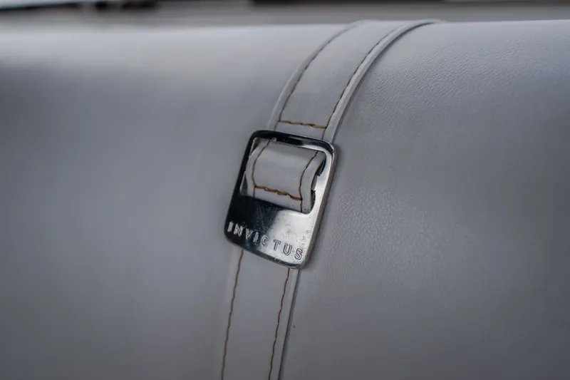 Slide: The Image of Close-up of Invictus TT430 2025 leather seat with branded metal buckle. - 31