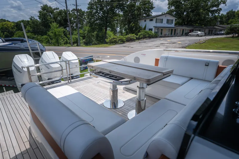 Slide: The Image of Luxurious 2025 Invictus TT430 yacht deck with seating and table, featuring powerful Mercury engines. - 20