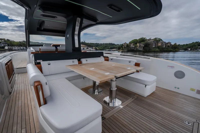 Slide: The Image of Luxurious 2025 Invictus TT430 yacht interior with elegant seating and wooden table on deck. - 32