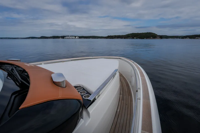 Slide: The Image of Invictus TT430 yacht cruising on calm waters, showcasing sleek design and luxury features. - 36