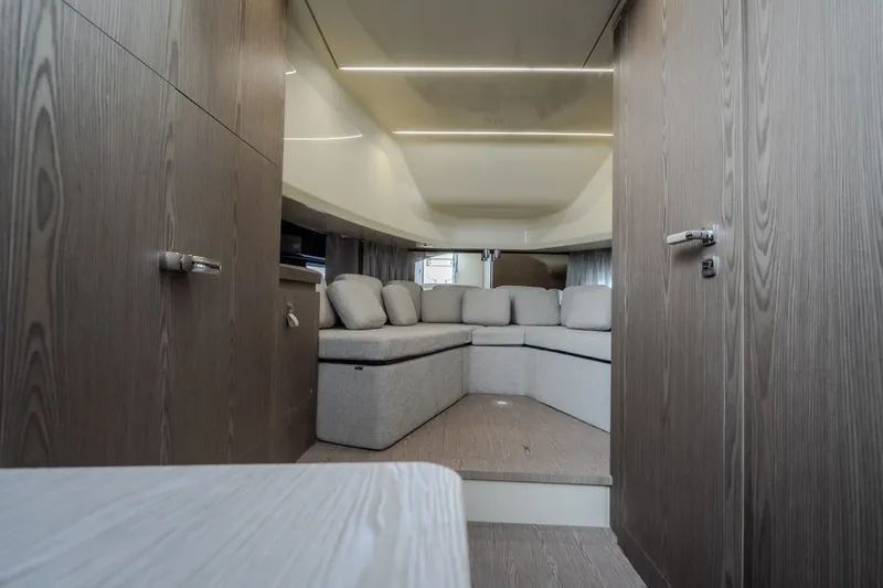 Slide: The Image of Interior of 2025 Invictus TT430 yacht with modern wood paneling and plush seating. - 69