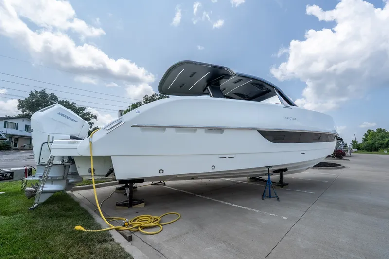 Slide: The Image of 2025 Invictus TT430 boat on trailer, parked outdoors under a cloudy sky. - 5
