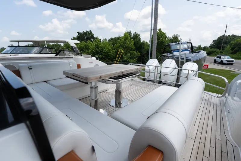 Slide: The Image of Luxurious 2025 Invictus TT430 yacht deck with sleek seating and modern table design. - 14
