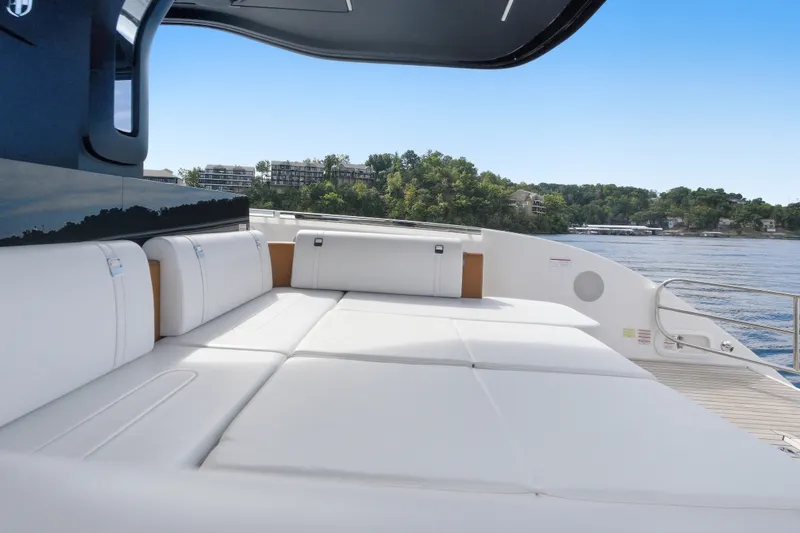 Slide: The Image of Luxurious 2025 Invictus TT430 yacht with spacious white seating, overlooking serene waters. - 92