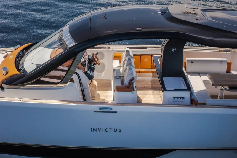 Slide: The Image of 2025 Invictus TT430 luxury yacht with sleek design and spacious deck on water. - 95