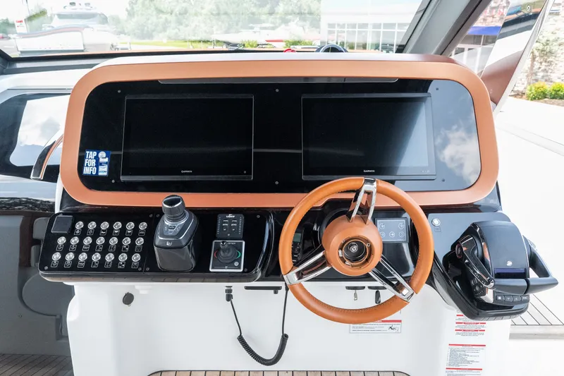 Slide: The Image of Cockpit of 2025 Invictus TT430 yacht with dual screens and leather steering wheel. - 35