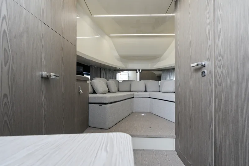 Slide: The Image of Interior of 2025 Invictus TT430 yacht with modern seating and wood paneling. - 77
