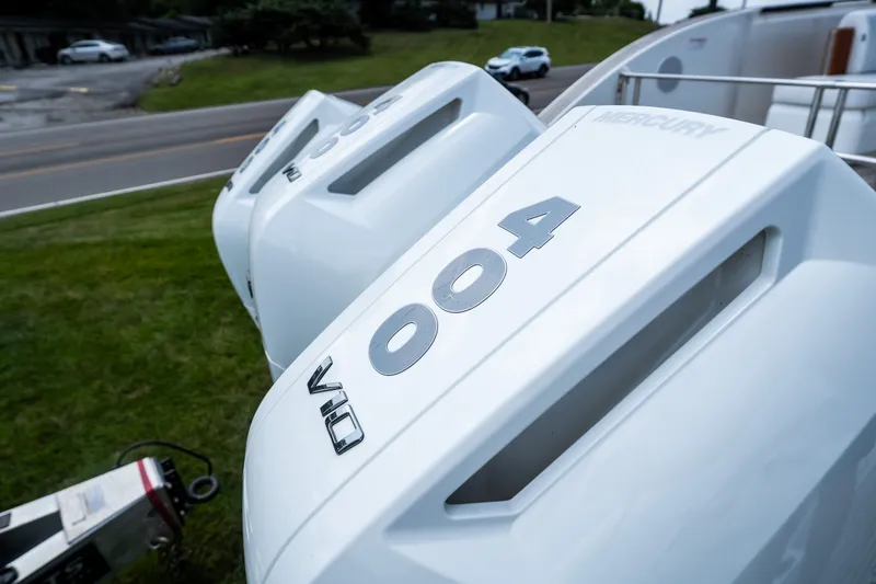Slide: The Image of Outboard motors on Invictus TT430, 2025 model, parked on grass near road. - 13