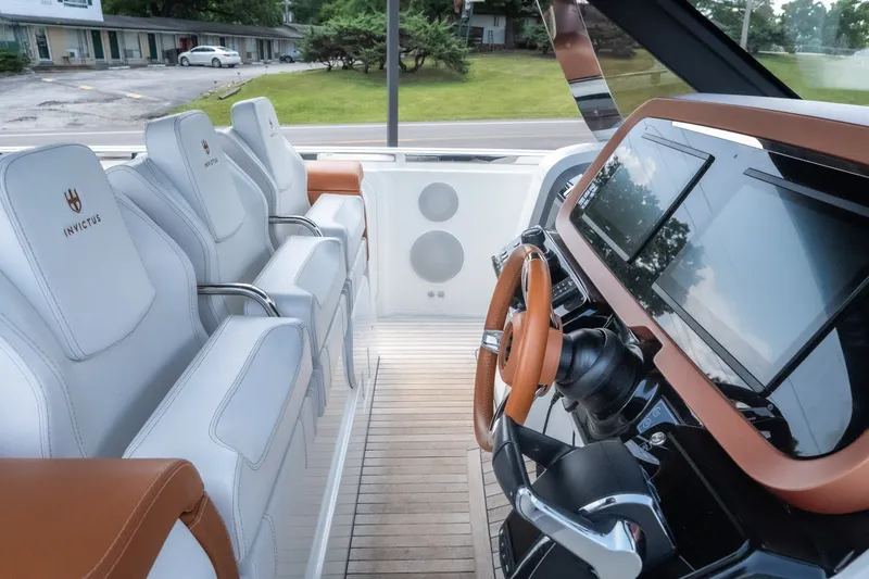 Slide: The Image of Interior of 2025 Invictus TT430 yacht, featuring luxurious seating and advanced navigation controls. - 39