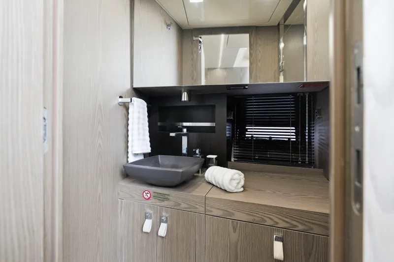 Slide: The Image of Modern bathroom interior of 2025 Invictus TT430 yacht with sleek sink and wooden cabinetry. - 79