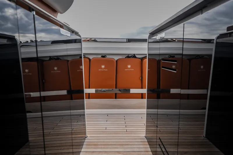 Slide: The Image of Luxurious Invictus TT430 yacht deck with sleek design and stylish orange accents, 2025 model. - 37
