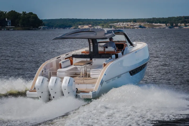 Slide: The Image of Luxury Invictus TT430 yacht cruising on a serene lake, 2025 model. - 107