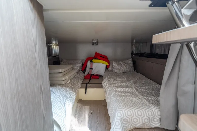 Slide: The Image of Cozy cabin interior of 2025 Invictus TT430 with twin beds and modern decor. - 31