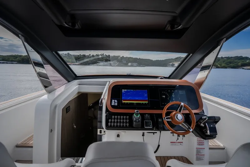 Slide: The Image of Interior view of 2025 Invictus TT430 yacht cockpit with modern navigation controls. - 46
