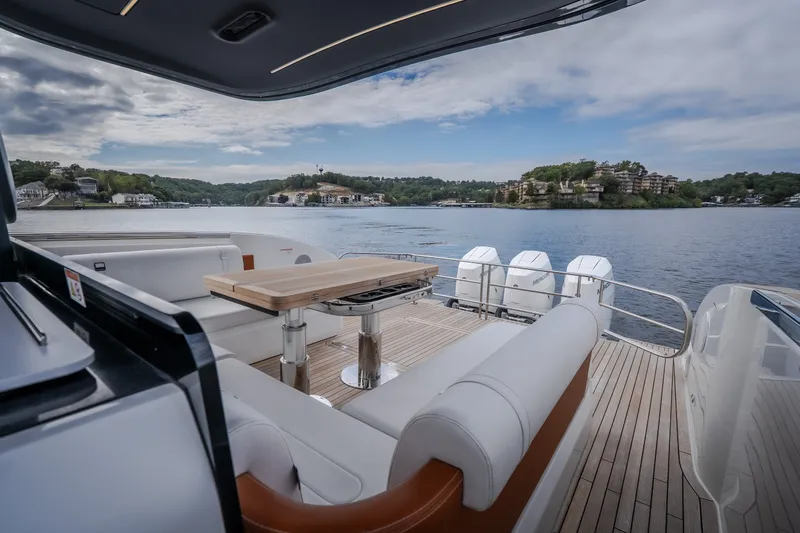 Slide: The Image of Luxurious 2025 Invictus TT430 yacht interior with scenic lake view and modern seating area. - 38