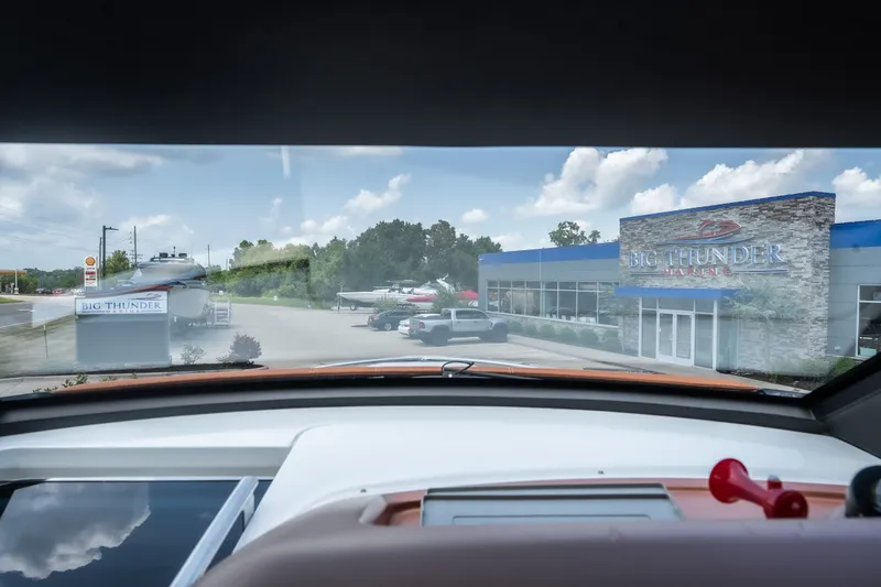 Slide: The Image of View from Invictus TT430, 2025, overlooking Big Thunder Marine dealership and parked boats. - 48