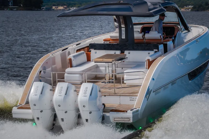 Slide: The Image of 2025 Invictus TT430 yacht cruising with triple Mercury 400 engines on a lake. - 106