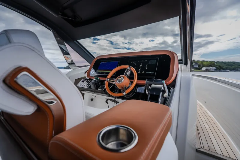 Slide: The Image of Luxurious helm of 2025 Invictus TT430 yacht with modern controls and leather accents. - 66