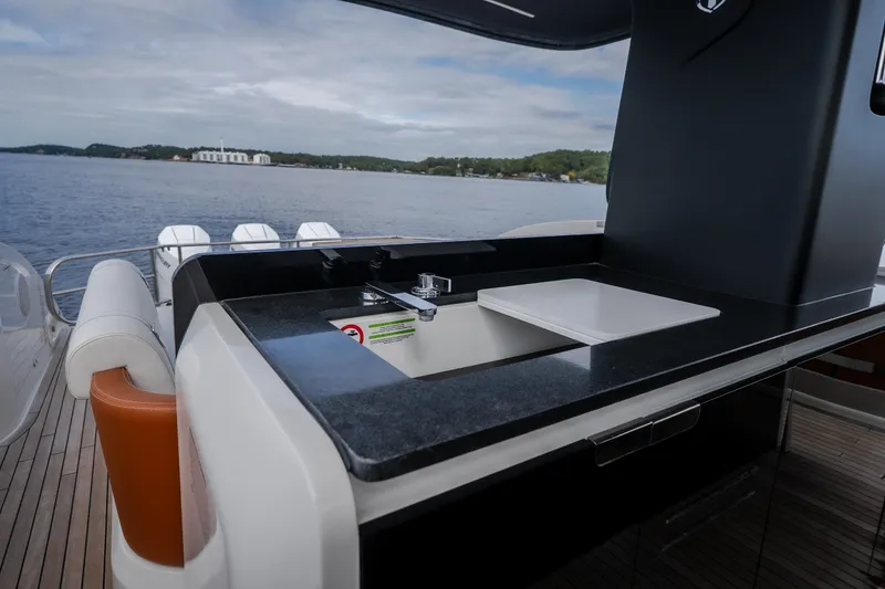 Slide: The Image of Luxury yacht Invictus TT430 2025 with sleek outdoor kitchen and scenic ocean view. - 41