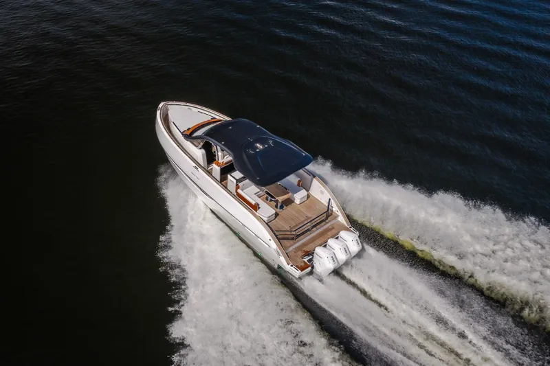 Slide: The Image of Aerial view of 2025 Invictus TT430 yacht cruising on open water. - 104