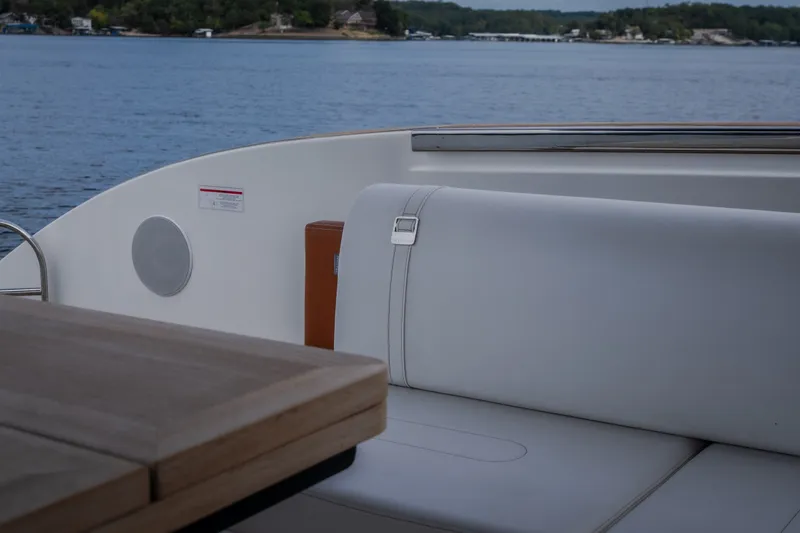 Slide: The Image of Invictus TT430 yacht interior, 2025 model, featuring elegant seating and scenic water view. - 63
