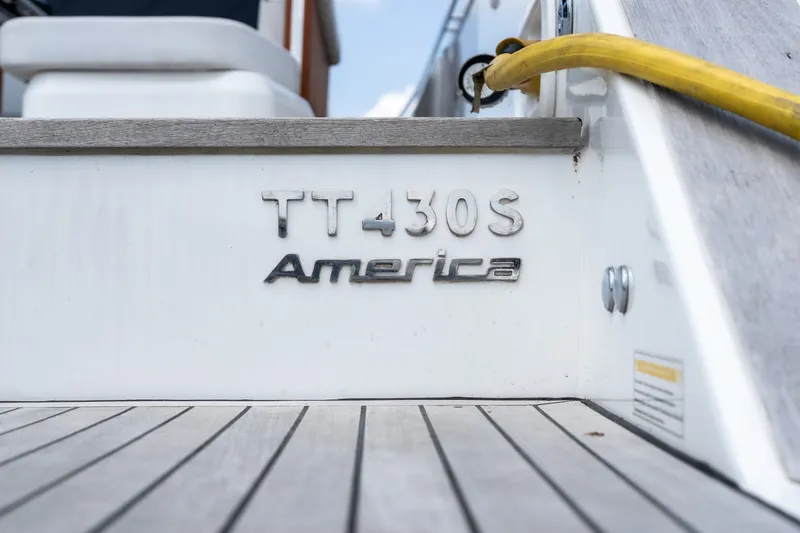Slide: The Image of 2025 Invictus TT430S America yacht deck with branding and yellow hose. - 9