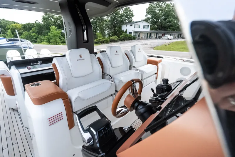 Slide: The Image of Interior of 2025 Invictus TT430 yacht with luxurious white and brown seating. - 40