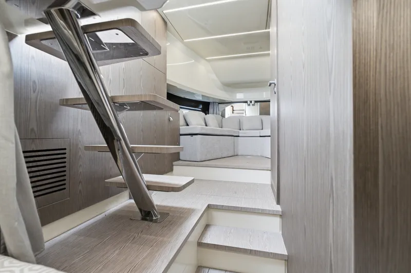 Slide: The Image of Interior of 2025 Invictus TT430 yacht, featuring modern wooden stairs and luxurious seating area. - 83
