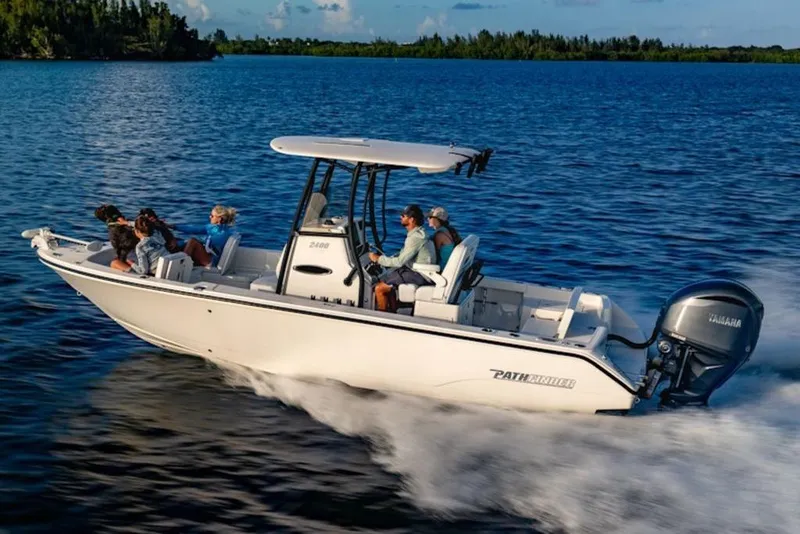 The Image of 2026 Pathfinder 2400 TRS boat cruising on a scenic lake with passengers enjoying the ride. - 1