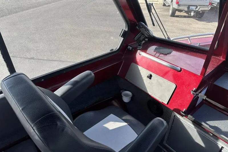 Slide: The Image of Interior of 2021 North River SEAHAWK 23 X 84 boat with black seats and red dashboard. - 7
