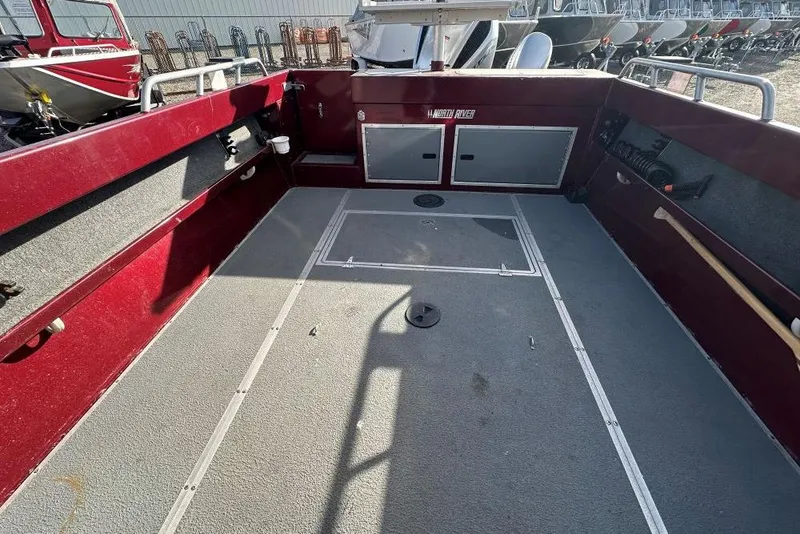 Slide: The Image of Interior view of a 2021 North River SEAHAWK 23 X 84 boat, featuring spacious deck and storage. - 9