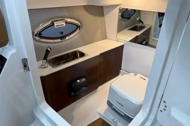 Slide: The Image of 2026 Chaparral SSX 6 boat interior with sink, mirror, and portable toilet. - 14