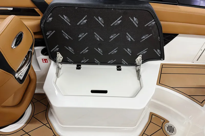 Slide: The Image of 2026 Chaparral SSX 6 boat interior with open storage compartment and tan seating. - 17