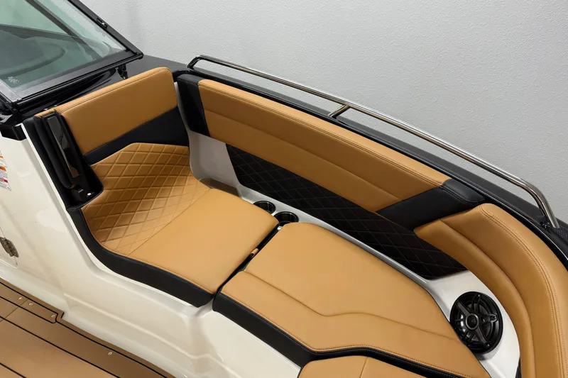 Slide: The Image of 2026 Chaparral SSX 6 boat interior with tan and black seating, diamond stitching, and speaker. - 25