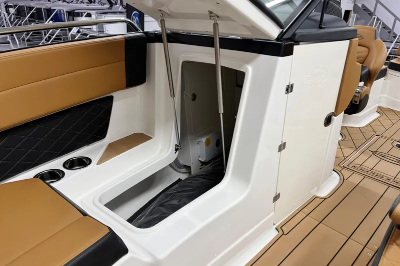 Slide: The Image of 2026 Chaparral SSX 6 boat interior with open storage compartment and tan seating. - 27