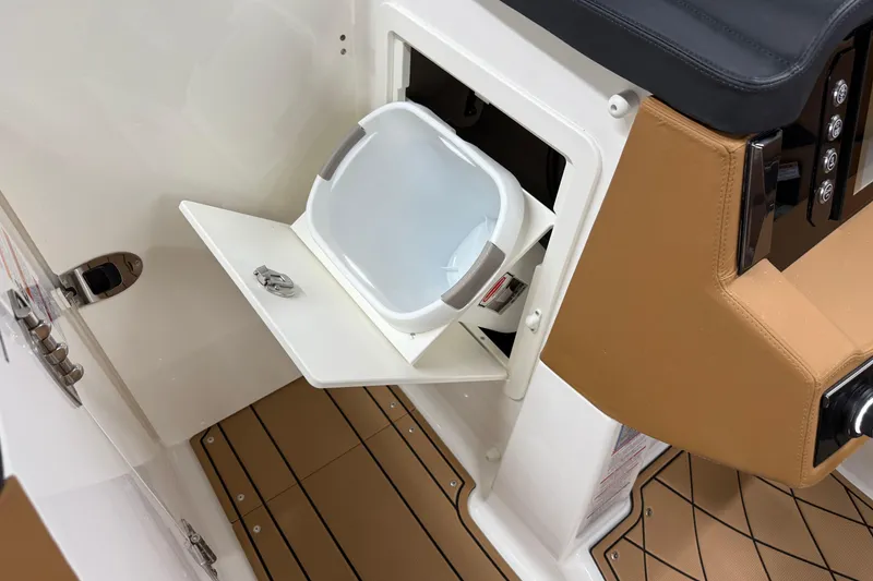 Slide: The Image of 2026 Chaparral SSX 6 boat interior with storage compartment and cushioned seating. - 29