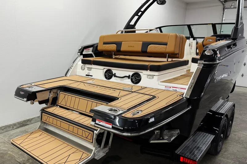 Slide: The Image of 2026 Chaparral SSX 6 boat with luxurious seating and sleek design in a showroom. - 3