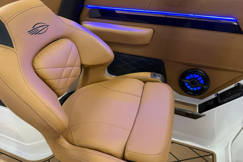Slide: The Image of Luxurious tan leather seat in 2026 Chaparral SSX 6 boat interior with blue LED lighting. - 39