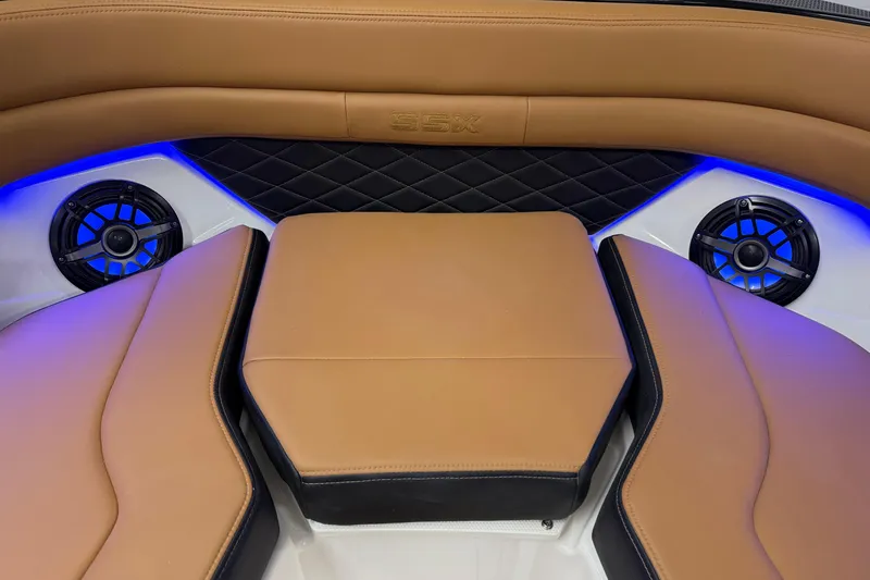 Slide: The Image of 2026 Chaparral SSX 6 boat interior with tan leather seats and blue LED lighting. - 40