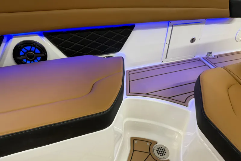 Slide: The Image of 2026 Chaparral SSX 6 interior with tan seating, blue LED lighting, and speaker system. - 41