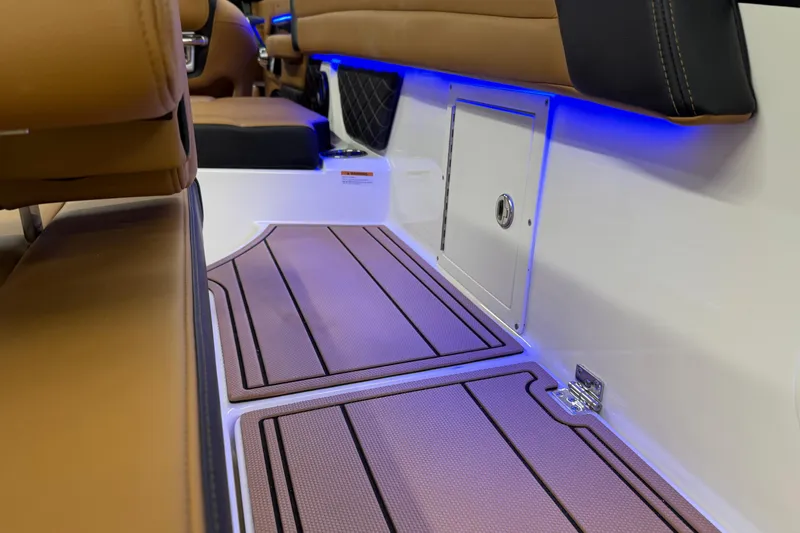 Slide: The Image of 2026 Chaparral SSX 6 boat interior with brown seating and blue LED lighting. - 42