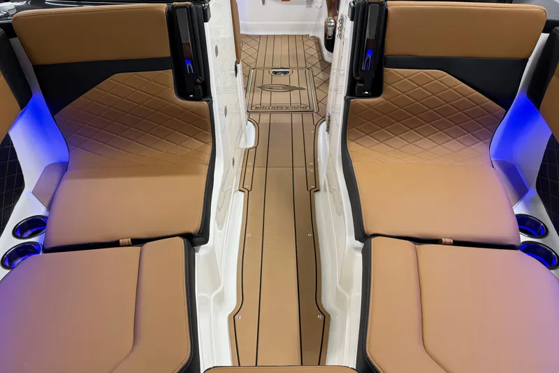 Slide: The Image of 2026 Chaparral SSX 6 interior with tan leather seats and ambient blue lighting. - 43