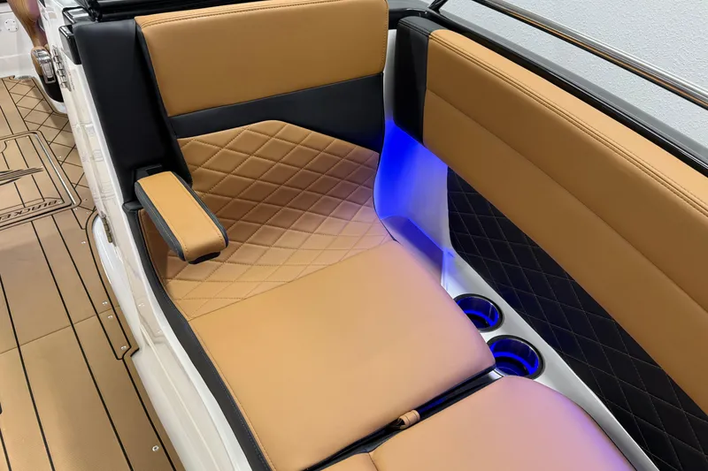 Slide: The Image of 2026 Chaparral SSX 6 boat interior with tan and black leather seating, blue LED lighting. - 44