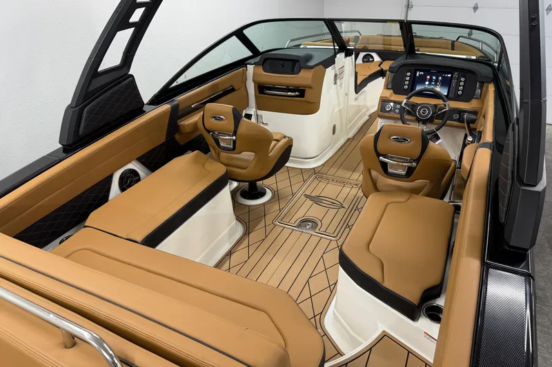 Slide: The Image of 2026 Chaparral SSX 6 boat interior with luxurious tan seating and modern dashboard. - 6