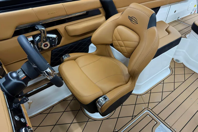 Slide: The Image of 2026 Chaparral SSX 6 boat interior with tan leather seat and modern steering controls. - 9