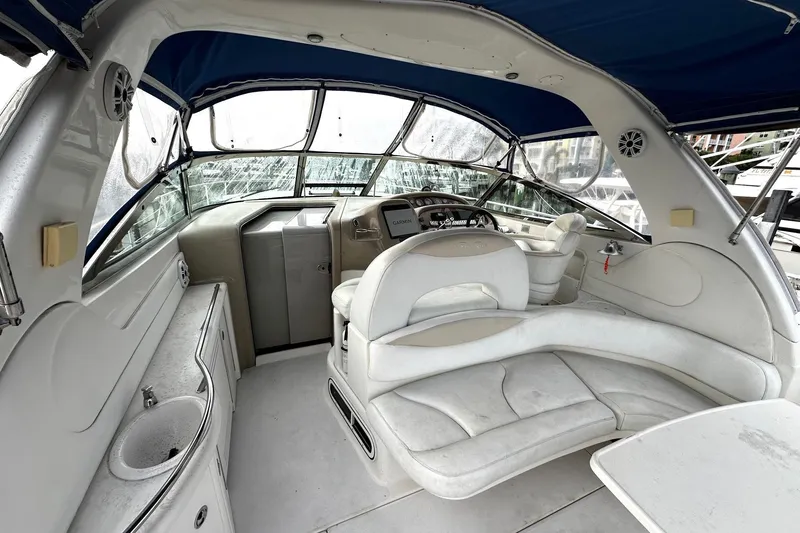 Slide: The Image of 2001 Sea Ray 380 Sundancer cockpit with white seating and blue canopy. - 13