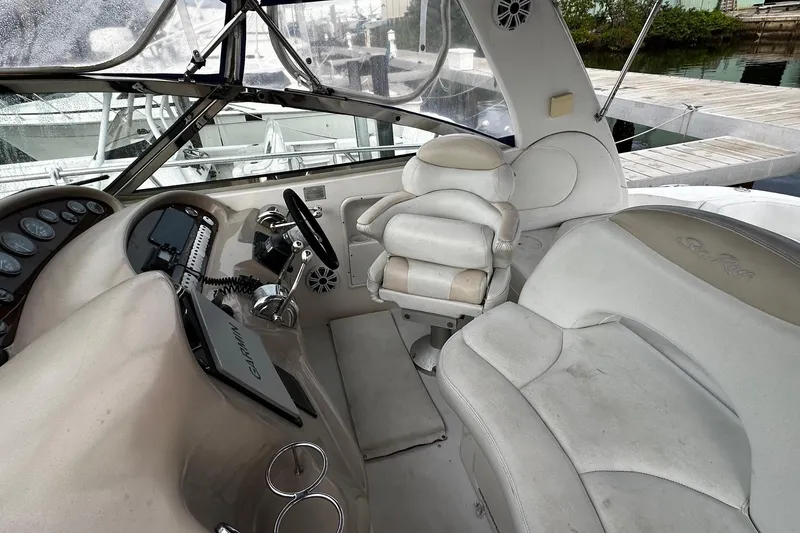 Slide: The Image of 2001 Sea Ray 380 Sundancer helm with steering wheel and seating area. - 15