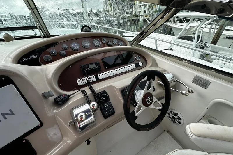 Slide: The Image of 2001 Sea Ray 380 Sundancer helm with steering wheel, gauges, and controls. - 17