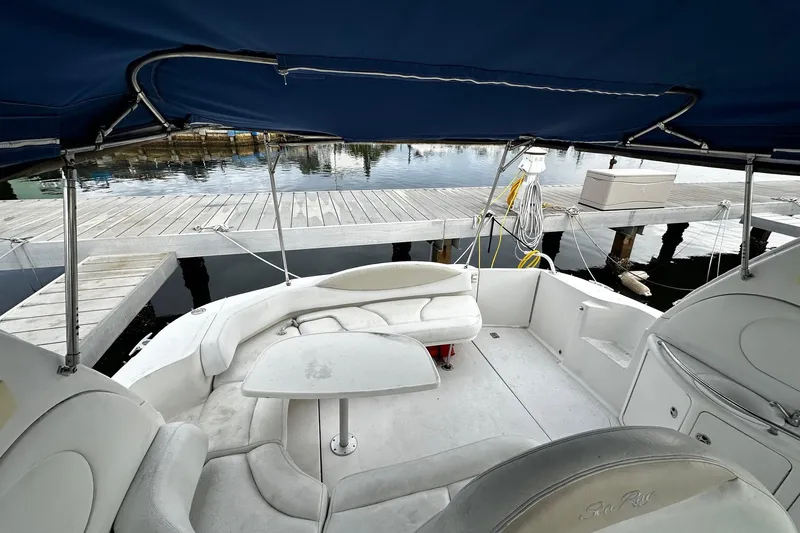 Slide: The Image of 2001 Sea Ray 380 Sundancer cockpit with seating, table, and dock view. - 18